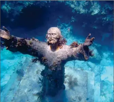  ?? Photo for The Washington Post by Roy Furchgott ?? Perhaps the most photograph­ed underwater site in the Keys, it is an eight-foot-tall bronze statue of Jesus in 25 feet of water.