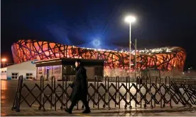  ?? Olympics. Photograph: Noel Celis/AFP/Getty ?? A member of security walks past the Beijing National Stadium, the venue for the opening and closing ceremonies of the 2022 Winter