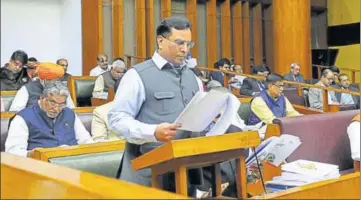  ?? KESHAV SINGH/HT ?? Haryana finance minister Capt Abhimanyu presenting the budget in the state assembly in Chandigarh on Friday.