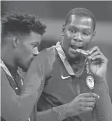  ?? RVR PHOTOS/ USA TODAY SPORTS ?? Jimmy Butler, left, and Kevin Durant celebrate on the medal podium after the USA won gold in men’s basketball Sunday.