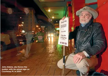  ??  ?? John Adams, aka Kenny the busker, with his seized sign on Courtenay Pl, in 2001.