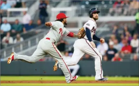  ?? TODD KIRKLAND — THE ASSOCIATED PRESS ?? Atlanta’s Ender Inciarte (11) is run down by Phillies shortstop Freddy Galvis (13) in the first inning Wednesday in Atlanta.