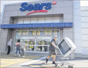  ?? CP PHOTO/RYAN REMIORZ ?? Bargain hunters are seen at the Sears store Friday, July 21, in St. Eustache, Quebec. Sears Canada is facing a social media campaign calling for a boycott after the company said it planned on paying millions in bonuses to keep executives on board...