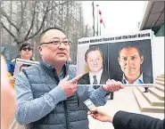  ?? AFP ?? A file photo shows Louis Huang of Vancouver Freedom and Democracy for China holding photos of Michael Spavor and Michael Kovrig in Vancouver, Canada.