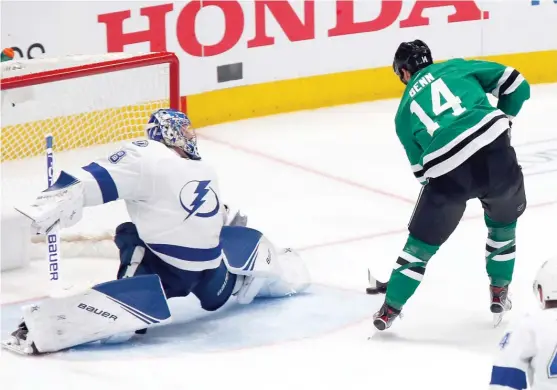  ?? RAY CARLIN/AP ?? Stars left wing Jamie Benn flips a backhand shot past Lightning goaltender Andrei Vasilevski­y during a game in January. Both teams in the final will start Russian goalies.