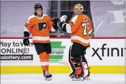  ?? CHRIS SZAGOLA — THE ASSOCIATED PRESS ?? Philadelph­ia Flyers’ Nolan Patrick, left, celebrates his goal with goaltender Carter Hart, right, during the first period against the Pittsburgh Penguins, Wednesday, in Philadelph­ia.