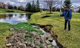  ?? NICK GRAHAM / STAFF ?? Mike Ekberg, manager of water data and analysis for the Miami Conservanc­y District, talks about how water flows from residentia­l and commercial developmen­ts to retention ponds to small streams and creeks to the Great Miami River.