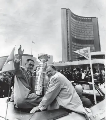  ?? DICK DARRELL/TORONTO STAR FILE PHOTO ?? Leafs captain George Armstrong, left, and owner Harold Ballard take the Cup to Nathan Phillips Square in 1967.