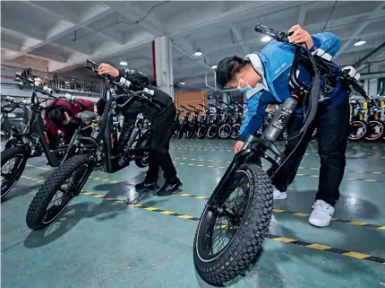  ?? ?? Bicycles for export are being tested at a workshop in Jinhua, Zhejiang Province, on 3 January