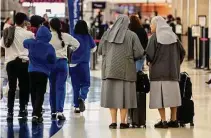  ?? William Luther/staff photograph­er ?? Two nuns head to the security checkpoint at San Antonio Internatio­nal Airport on the day before Thanksgivi­ng last month, traditiona­lly the year’s busiest travel day.