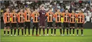  ?? Bernat Armangue / Associated Press ?? Shakhtar players take a moment of silence in memory of the victims of the Indonesian stadium disaster prior to the start of the Champions League group F soccer match between Real Madrid and Shakhtar Donetsk at the Santiago Bernabeu stadium in Madrid on Wednesday.