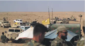  ?? AFP ?? Coalition forces and members of the Syrian Democratic Forces gather near the village of Susah in the eastern province of Deir Ezzor, near the Syrian border with Iraq, in September