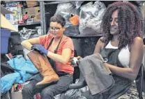  ?? KENN OLIVER/THE TELEGRAM ?? Margaret Hart (left) and Jemila Mohammed give some donated footwear a quick shine before putting it on the shelves at Take Two.