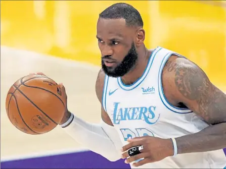  ?? AP FILE ?? Los Angeles Lakers forward LeBron James dribbles during the first half against the Washington Wizards on Monday in Los Angeles.