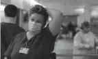  ?? DISPATCH GAELEN MORSE/COLUMBUS ?? ICU nurse Trudy Halstead walks through the hallway exhausted after a 12-hour shift inside Mount Carmel Grove City Hospital’s COVID-19 ward in December 2020.