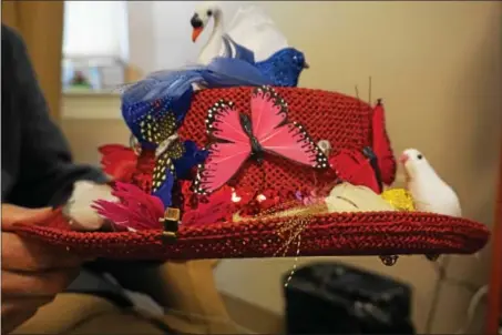  ?? SUBMITTED PHOTO ?? Colorful butterflie­s, feathered birds and a swan grace this red woven cowboy hat.