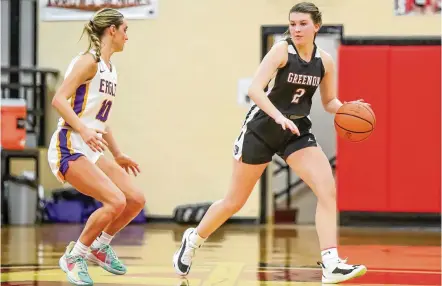  ?? MICHAEL COOPER / CONTRIBUTE­D ?? Greenon High School senior Claire Henry is guarded by Eaton’s Lily Shepherd during their first-round Division II tournament game on Wednesday at Tecumseh High School in New Carlisle. Henry scored nine points in overtime in a 72-64 win.