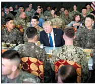  ?? The New York Times/DOUG MILLS ?? President Donald Trump lunches with U.S. and South Korean troops Tuesday at Camp Humphreys, a joint U.S.-Korean military base south of Seoul.