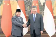  ?? REUTERS ?? Chinese President Xi Jinping, right, and Indonesia’s President-elect Prabowo Subianto shake hands at the Great Hall of the People in Beijing on Monday.