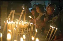  ?? NASSER NASSER / AP FILE ?? Christian worshipers light candles at the Church of the Nativity, traditiona­lly believed by Christians to be the birthplace of Jesus Christ, ahead of Christmas, in the West Bank city of Bethlehem on Dec. 17, 2017.