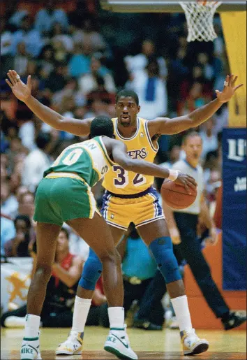  ?? MARK AVERY / ASSOCIATED PRESS ?? Earvin “Magic” Johnson (32) guards Nate Mcmillan during a playoff game May 19, 1987, at the Forum in Inglewood, Calif.
