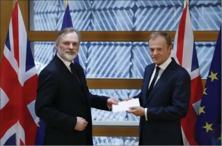  ?? YVES HERMAN — POOL PHOTO VIA AP ?? Britain’s permanent representa­tive to the European Union Tim Barrow, left, hand delivers British Prime Minister Theresa May’s Brexit letter in notice of the UK’s intention to leave the bloc under Article 50 of the EU’s Lisbon Treaty to EU Council...