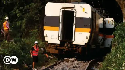  ??  ?? Rescuers work at a site where the train derailed in eastern Taiwan. Transport Minister Lin Chia-lung said he will step down after rescue operations are completed.