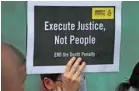  ?? — Reuters ?? A demonstrat­or from Amnesty Internatio­nal holds a placard outside the Central Prison to protest against the death penalty in Bangkok.