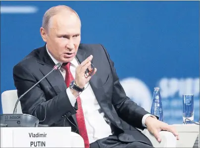  ?? AP PHOTO ?? Russian President Vladimir Putin answers a question at the St. Petersburg Internatio­nal Economic Forum in St. Petersburg, Russia, Friday.