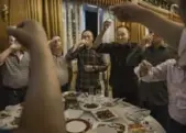  ??  ?? Chinese men toast each other with baijiu.