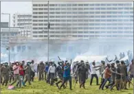  ?? (AFP) ?? Demonstrat­ors and government supporters clash outside the official residence of Sri Lanka’s Prime Minister Mahinda Rajapaksa in Colombo on Monday.