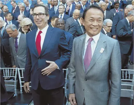  ?? AP PHOTO ?? TRADE TENSION: U.S. Treasury Secretary Steven Mnuchin, left, and Japan’s Finance Minister Taro Aso attend the Internatio­nal Monetary Fund governors’ group photo at the World Bank/IMF spring meetings in Washington yesterday.