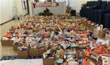  ?? (Pine Bluff Commercial/Byron Tate) ?? Groceries to be handed out Monday fill much of the ground floor of the House of Bread Church. About 450 boxes of food were distribute­d by the end of the day, said Saint Mary Harris, pastor of the church.