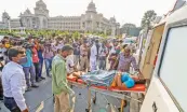  ??  ?? Family members bring a Covid-19 positive patient in front of Vidhana Soudha to protest as they did not get a bed at a government hospital in Bengaluru on Thursday.