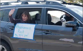  ?? NEWS-SENTINEL PHOTOGRAPH­S BY BEA AHBECK ?? First-grade teacher Shelly Schatz waves to students during the Reese Elementary School teachers car parade in their students’ neighborho­od in Lodi on Friday.