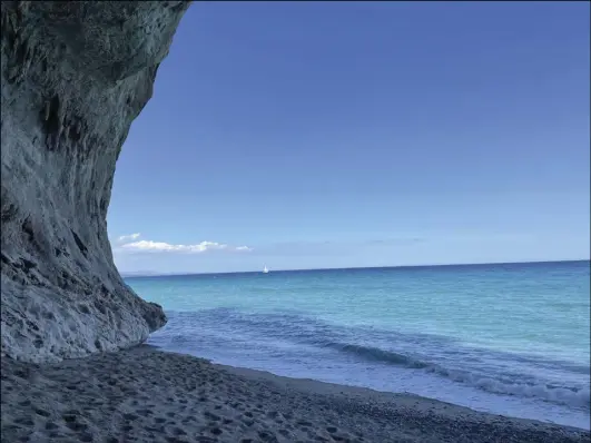  ?? ?? The beach at Cala Luna, backed by limestone cliffs and only accessible by foot or boat, is considered one of the prettiest in Sardinia.