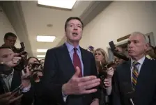  ?? AP ?? BACK ON THE HILL: Ex-FBI Director James Comey, with his attorney David Kelley, right, speaks to reporters after a day of testimony before the House Judiciary and Oversight committees on Capitol Hill yesterday.