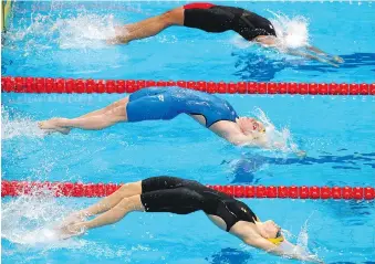  ?? ADAM PRETTY/GETTY IMAGES ?? Kylie Masse of Canada, top, out-duelled Emily Seebohm of Australia, centre, and Holly Barratt of Australia in the 100m backstroke heats at the Budapest world championsh­ips Monday, using her superior back-end speed to post a Canadian-record time of...