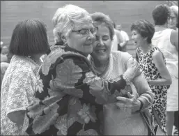  ?? STOCKTON RECORD PHOTOGRAPH­S BY CLIFFORD OTO ?? Kathy Hart, left, gets a hug from Harriet Doyle during Hart’s retirement reception Wednesday evening at San Joaquin Delta College’s Blanchard Gym.