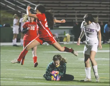  ?? DAVID WITTE/NEWS-SENTINEL ?? Galt's Mia Miron (21) leaps to avoid a collision with Tokay goalkeeper Mia Misasi after Misasi slid in to grab the ball during Tokay's 3-2 victory on Thursday at the Grape Bowl.