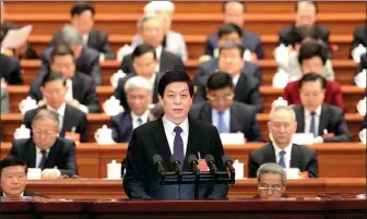  ?? XU JINGXING / CHINA DAILY ?? Li Zhanshu, chairman of the Standing Committee of the National People’s Congress, delivers a work report of the committee to national legislator­s at the Second Plenary Meeting of the Second Session of the 13th National People’s Congress on Friday.