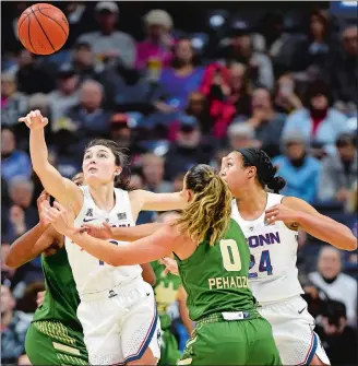  ?? SEAN D. ELLIOT/THE DAY ?? UConn’s Molly Bent (10) tips the ball away from South Florida’s Enna Pehadzic (0) in the first half of Sunday’s AAC women’s basketball game at Gampel Pavilion in Storrs. UConn won 63-46.