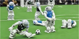  ??  ?? Robots fight for the ball during their football match in the standard platform league tournament at the RoboCup 2017.