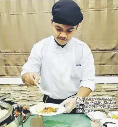  ??  ?? A chef pouring soya sauce to finish the Roasted Chicken Rice Balls before serving the dish to a guest.