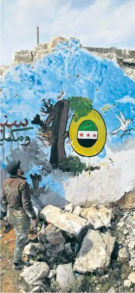  ??  ?? Die Friedensta­ube macht sich auf den Weg: aktuelles Wandbild in der Provinz Idlib