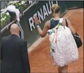  ?? Associated Press ?? Japan’s Naomi Osaka leaves after losing against Amanda Anisimova, of the U.S., during their first-round match at the French Open, Monday, in Roland Garros stadium in Paris, France.