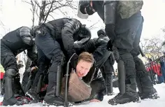  ?? — AFP ?? Police detain a man during a rally in support of jailed Opposition leader Alexei Navalny in Saint Petersburg on Sunday.