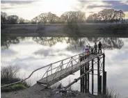  ?? Rich Pedroncell­i / Associated Press 2016 ?? People try to catch fish from the Sacramento River near Courtland. Gov. Jerry Brown’s plan would build two tunnels to move water through the delta.