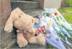  ?? Pictures: Steven Brown. ?? Top: A police office stationed outside the Kinloss Crescent block yesterday. Above: Tributes laid at the scene.