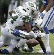  ?? SETH WENIG - THE ASSOCIATED PRESS ?? Indianapol­is Colts running back Robert Turbin, bottom right, fumbles the ball as New York Jets defensive back Rontez Miles (45) and defensive end Leonard Williams (92) defend during the first half of an NFL football game, Sunday, Oct. 14, 2018, in East Rutherford, N.J. The Jets recovered the fumble.